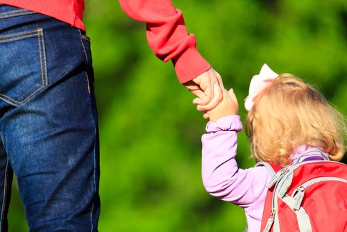 parent taking child to daycare